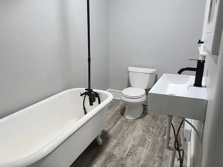 Renovated bathroom with updated fixtures and new sink & toilet