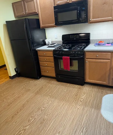Large kitchen with solid surface counter tops and luxury vinyl plank floors