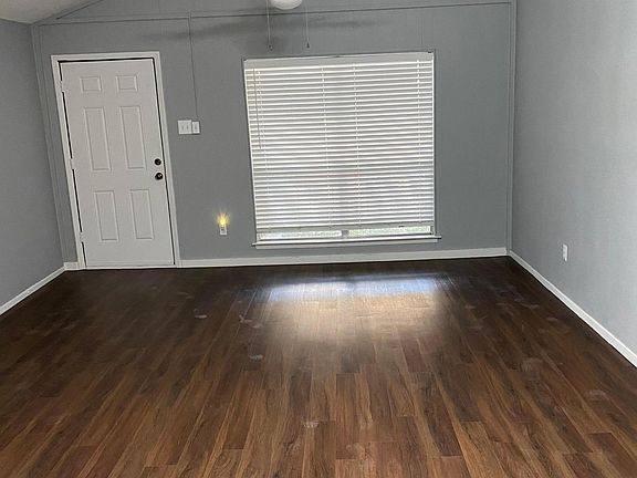 Living/Dining area with 2 in faux wood blinds closed.