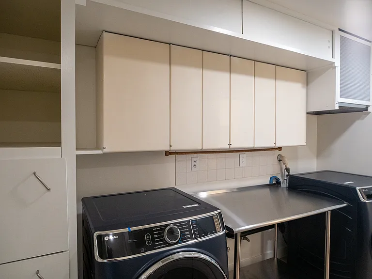 Laundry room features a lot of storage with new larger washer and dryers. New stainless steel table helps you maximize the space and making doing laundry a breeze.