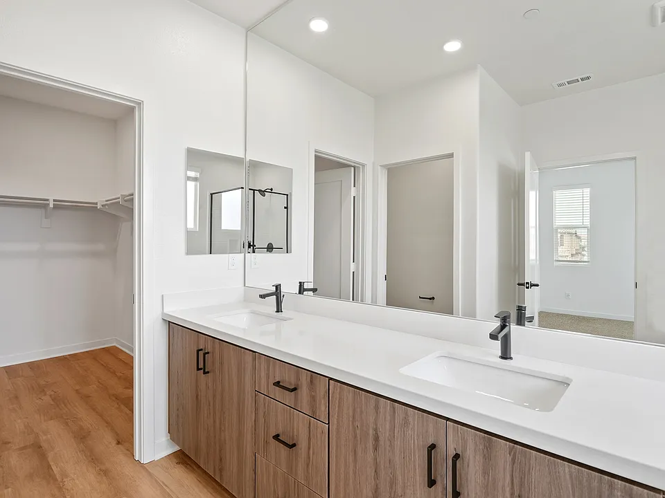 Dual sink ensuite and large walk-in closets in select homes.