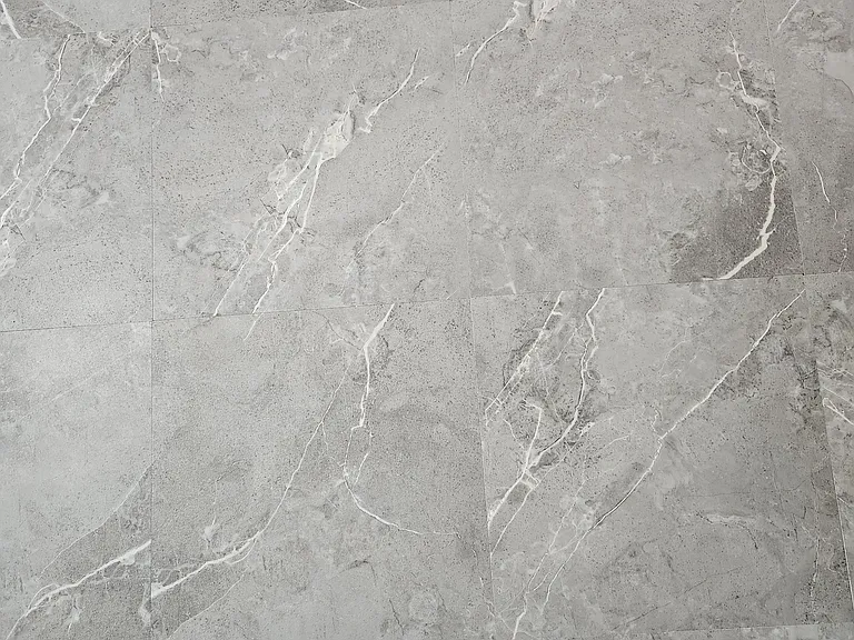 Close-up view of new tile installed in kitchen, storage area and bathrooms.