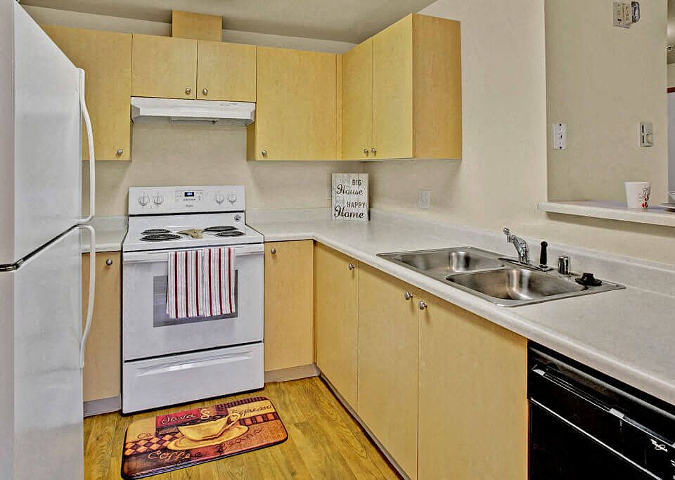 A kitchen with lots of counter space cabinet storage, and a bar