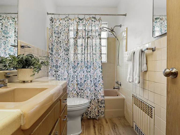 Super cute bathroom with retro features -- I just had to keep them, they are so cool. New floors and check out the window in the bathroom. BIG bathroom too.