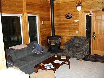 Looking inside of the living room area viewing to the front door. All furnishings stay with the home