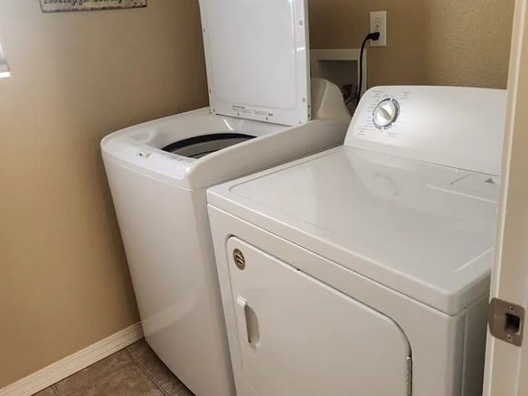 In unit washer and dryer conveniently located near bedrooms.