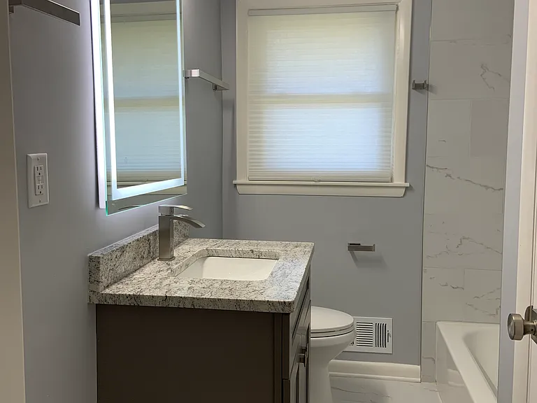 Hallway bathroom with fog less mirror, granite top.