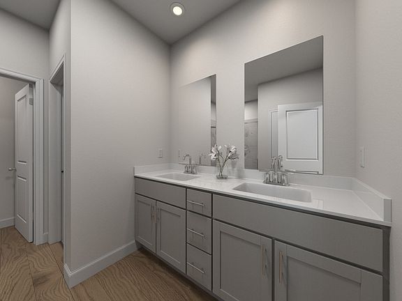 The primary bathroom offers dual vanity sinks and a walk-in shower.