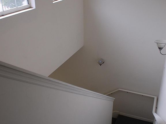 Stairwell to upstairs bedrooms and 2 baths. Lots of light in this house.