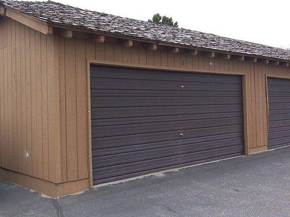 Double car garage with two cars inside and outside. Total of 4 parking spaces.