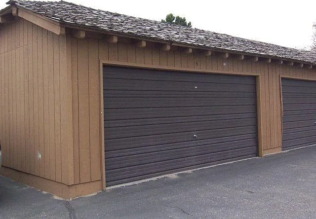 Double car garage with two cars inside and outside. Total of 4 parking spaces.