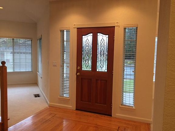 Inside entry hall, left room is formal living room, to the right formal dining room