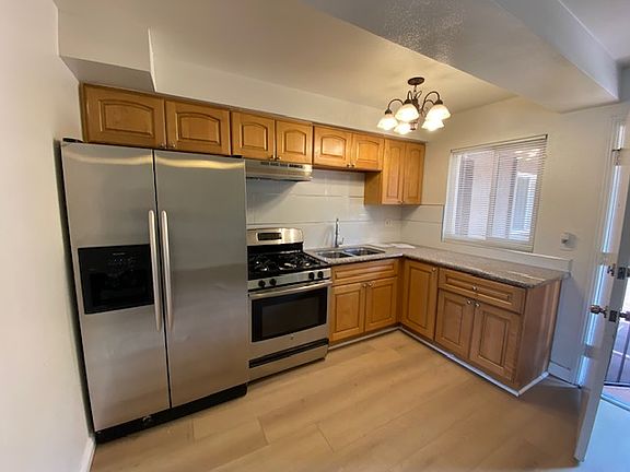 Clean Kitchen. Stainless Refrigerator, Stove.