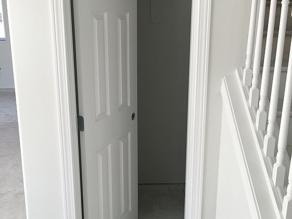 ENTRY STAIRS AND COAT/SHOE CLOSET WITH ADDED UNDER STAIR STO