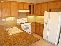 Kitchen with Granite Slab Counters and oak cabinets
