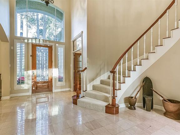 Stately entry with abundant natural light and sweeping staircase greets your guests.