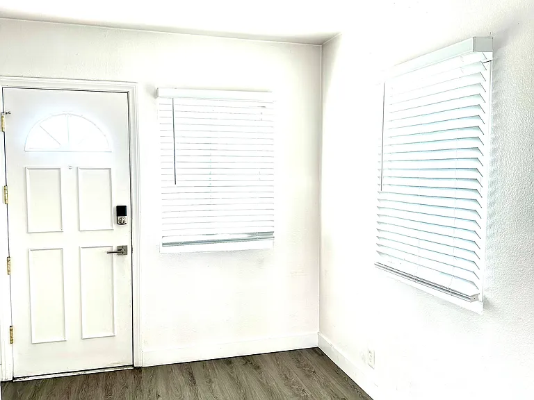 Kitchen area also has a back door that leads to a passage way to garage on side of building