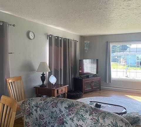 another living room view. Notice large windows