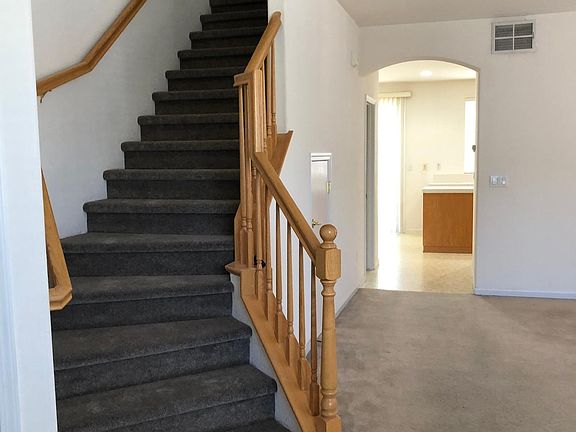 Stairs up to Living Quarters, Living /Dining Room to the right and Kitchen in the back. Storage Room under the stairway.