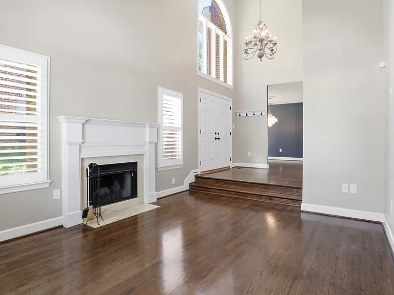Living Room with Fireplace and Vaulted Ceilings with View to Foyer
