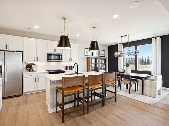 The sprawling kitchen, with the dining room behind it