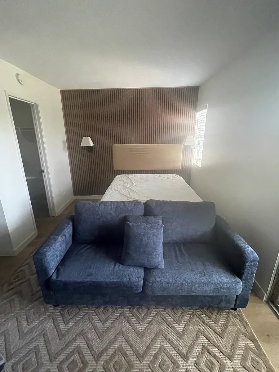 Studio living area is big enough for a queen bed, night stand, sofa, and entertainment center. - 4060 Huerfano Ave #225