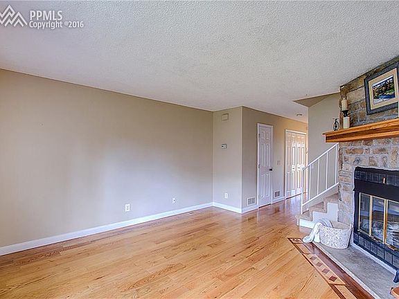 Oak floors have beautiful detail inset around fireplace hearth.
