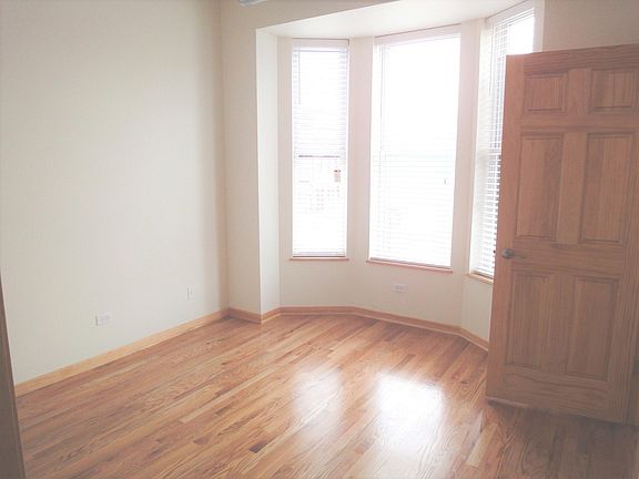 Front living room window facing east and door to the front second bedroom