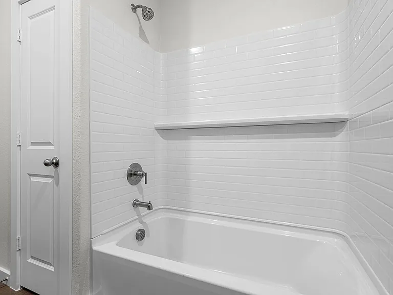 The secondary bathroom has a shower-tub combo.