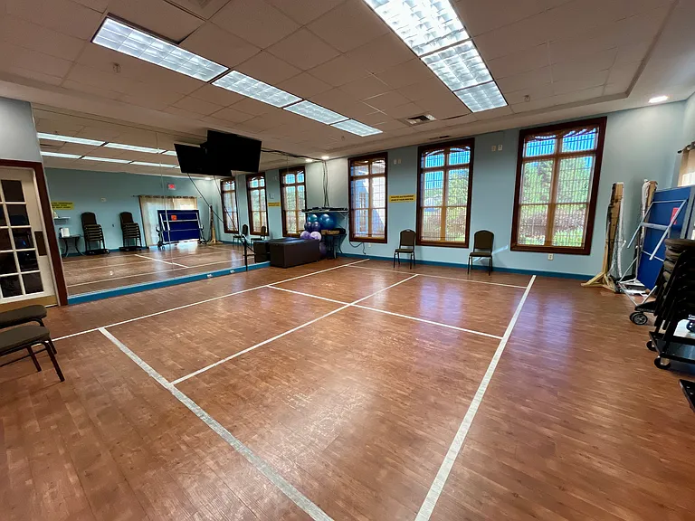 Mirrored Fitness Studio with Mats and Exercise Balls
