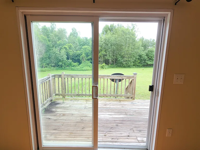 Slide glass door to back deck showing back yard.