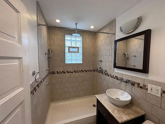 Bathroom with waterfall head shower and body jets