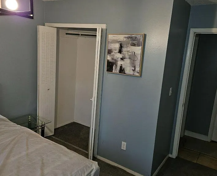 Private bedroom with carpeted flooring, overhead lighting, and a closet for everyday storage plus easy hallway access.