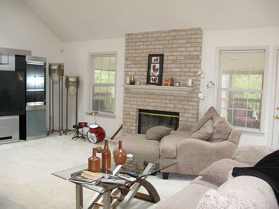 foyer looking into family room with fire place access to huge screen in porch