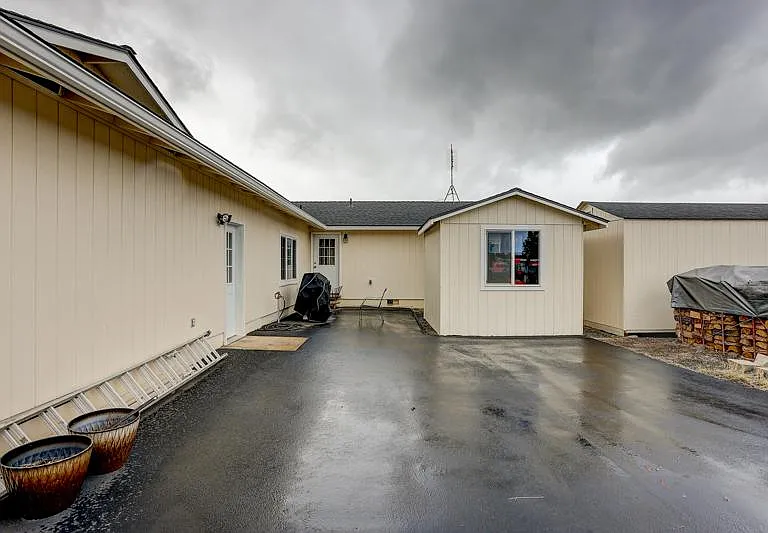 View of back of house and door to garage and laundry room.