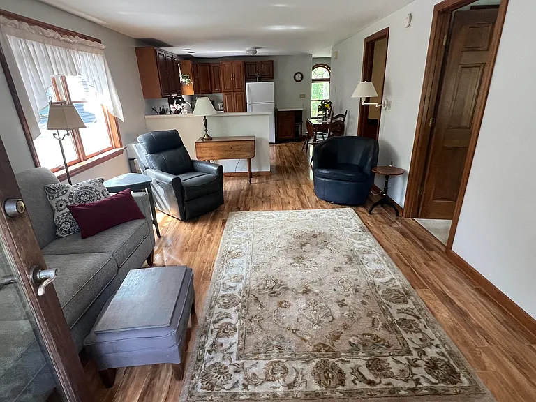 main entrance into open and bright livingroom/kitchen area