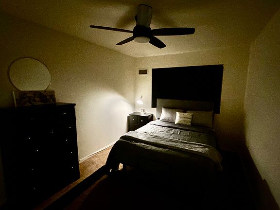 Night scenery in bedroom. Comfy queen bed, ceiling fan, black out shades. Plenty of closet & storage space.