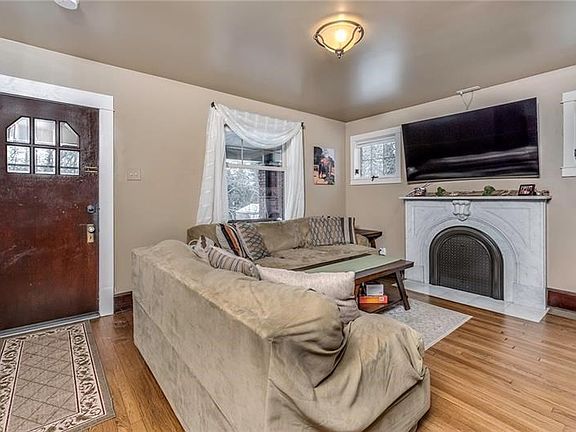The Living Room Features a Gorgeous Marble Decorative Fireplace Surround