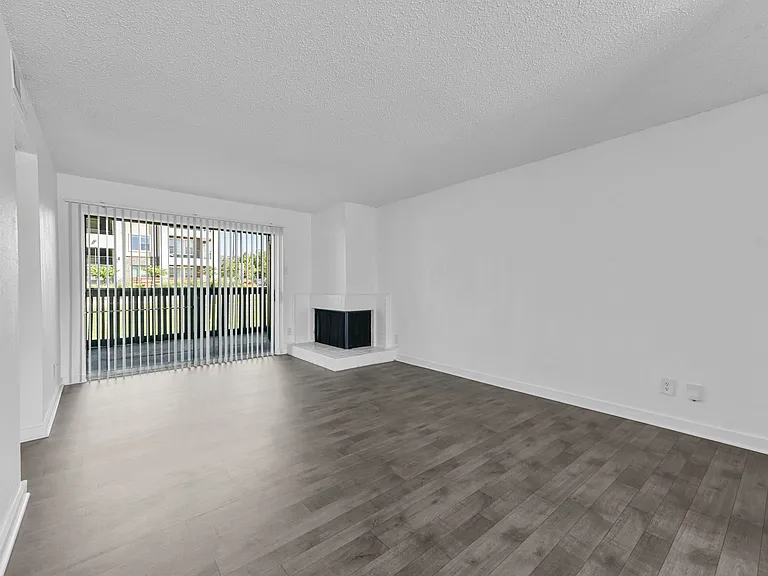 Spacious open floor plan with access to kitchen and fireplace with sliding door