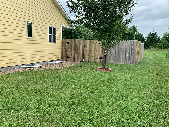 Right side of house w/ pear tree.