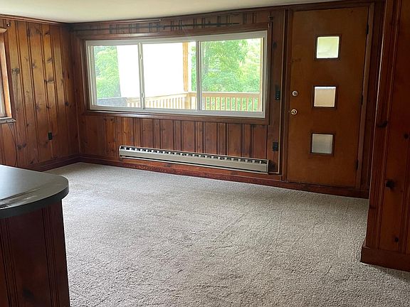 Living room with entrance to private, lower-level back deck.