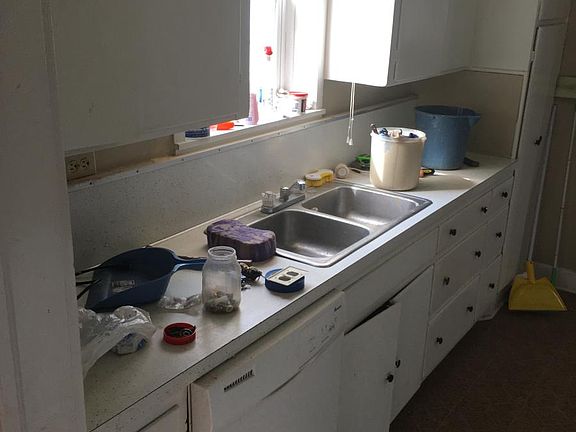 kitchen with dishwasher and cabinet storage