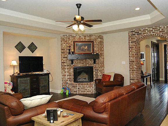 Sophistication and casual elegance unite in the Family Room with the floor to ceiling bricked firepl