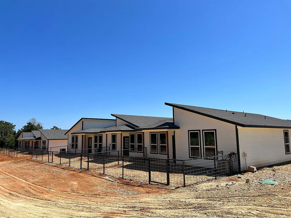 Back of triplex. Now has grass. - 2232-J E Woody Rd #102 & 105
