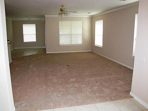 And to the right is a spacious living room with floor plug. Two inch blinds thruout.  The breakfast area is in the back left corner of this picture.