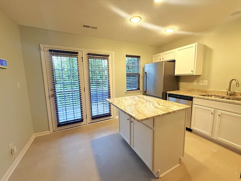 Kitchen island provides a place for food preparation and consumption.