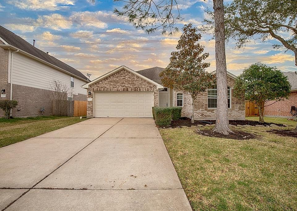 Beautiful four-bedroom home with lush landscaping and fantastic curb appeal.