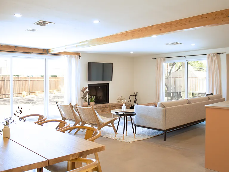 Spacious living room with fireplace and direct access to backyard.