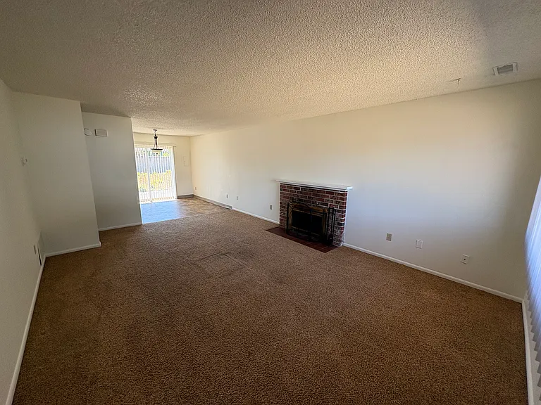 Living room looking to dining room, wood burning fireplace