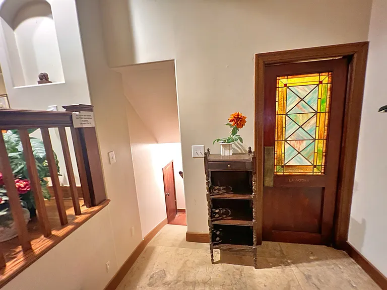 To the right is door to the bathroom ( first floor by the entrance). To the left are the stairs leading to the garage (unavailable) and can be used as an extra storage.
